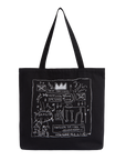 A black canvas tote bag with two shoulder straps, featuring a white hand-drawn style graphic print on the front with text and doodles, photographed against a plain white background.