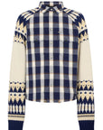 A long-sleeve button-up shirt with a navy blue and cream plaid body, transitioning into a cream and navy Fair Isle patterned knit on the sleeves and shoulders, finished with navy ribbed cuffs and collar.