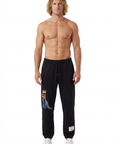 Blond male model wearing the Basquiat sweatpants on a pure white background