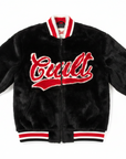 A young man wearing a black faux fur varsity jacket with red and white trim and 'Gucci' written across the chest in red and white lettering, set against a plain white background.