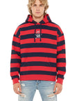 Person wearing a red and navy striped hoodie with a logo on a white background