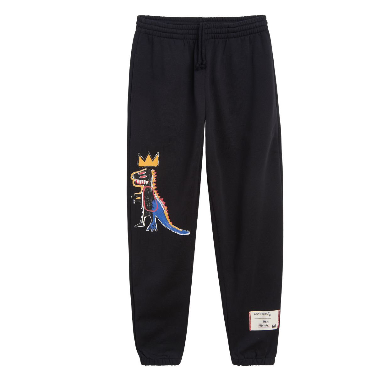 Black Rome Pays Off Basquiat ‘Pez Dispenser’ sweatpants with crowned dinosaur artwork and woven lower-leg label.