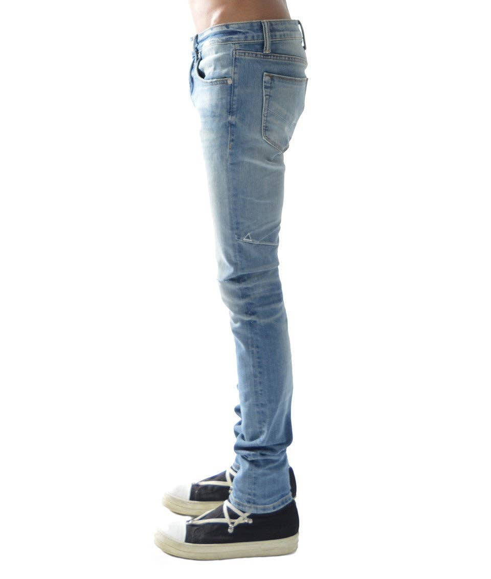 male model wearing HVMAN STRAT light blue super skinny jeans side