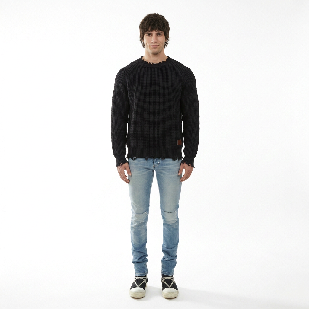 Model wearing HVMAN ‘STRAT’ light blue super skinny jeans with a black DSquared2 knit sweater.”