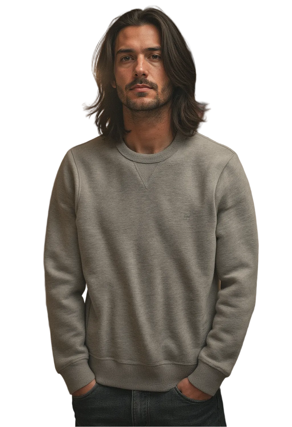 Man wearing a gray sweatshirt standing in a room with blurred people in the background