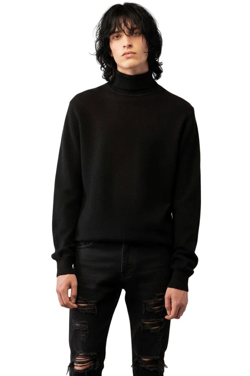 Male model with black hair and wearing a black turtleneck cashmere sweater and distressed black jeans