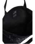 Black canvas tote bag shown from the inside, featuring black webbing handles and a black interior label that reads 'ROME PAYS OFF'.