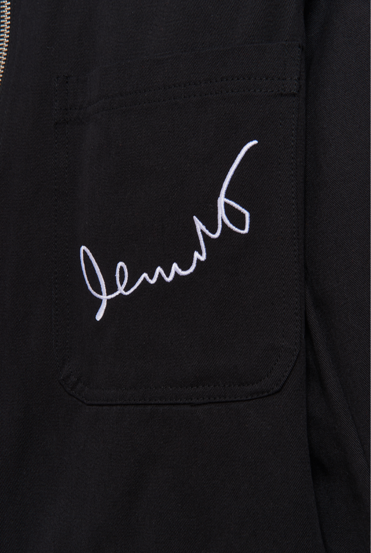 Black jacket with white embroidered text on a white background