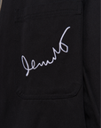 Black jacket with white embroidered text on a white background