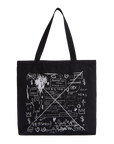 A black canvas tote bag with two shoulder straps, featuring a white hand-drawn graffiti-style graphic print on the front with text and symbols.