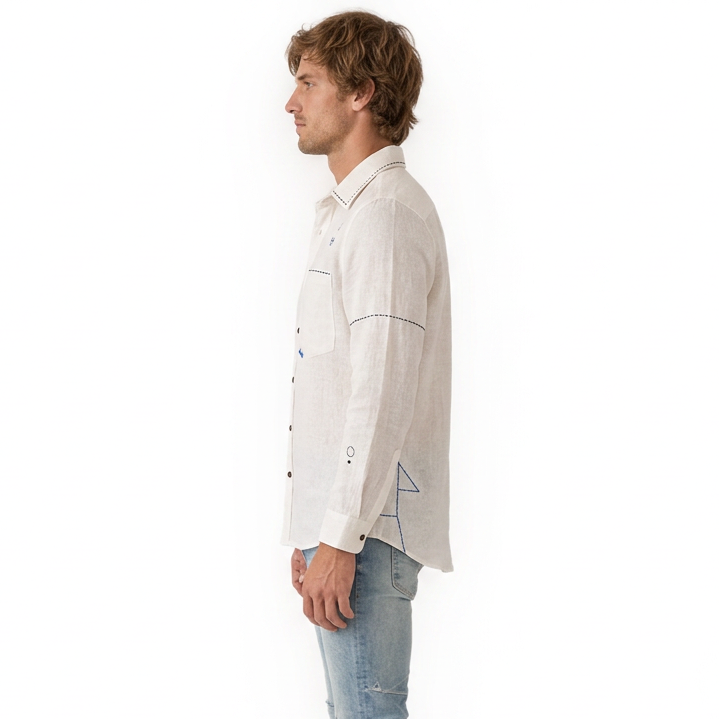 Side view of model wearing Live Linen "Atticus" embroidered linen shirt with light blue jeans