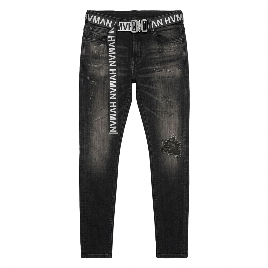 Front flat lay of HVMAN “STRAT” Black Shale super skinny jeans with included HVMAN-branded belt on white