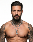 Shirtless tattooed male model wearing a polished silver chain and Double Cross Gothic H initial pendant on a white background