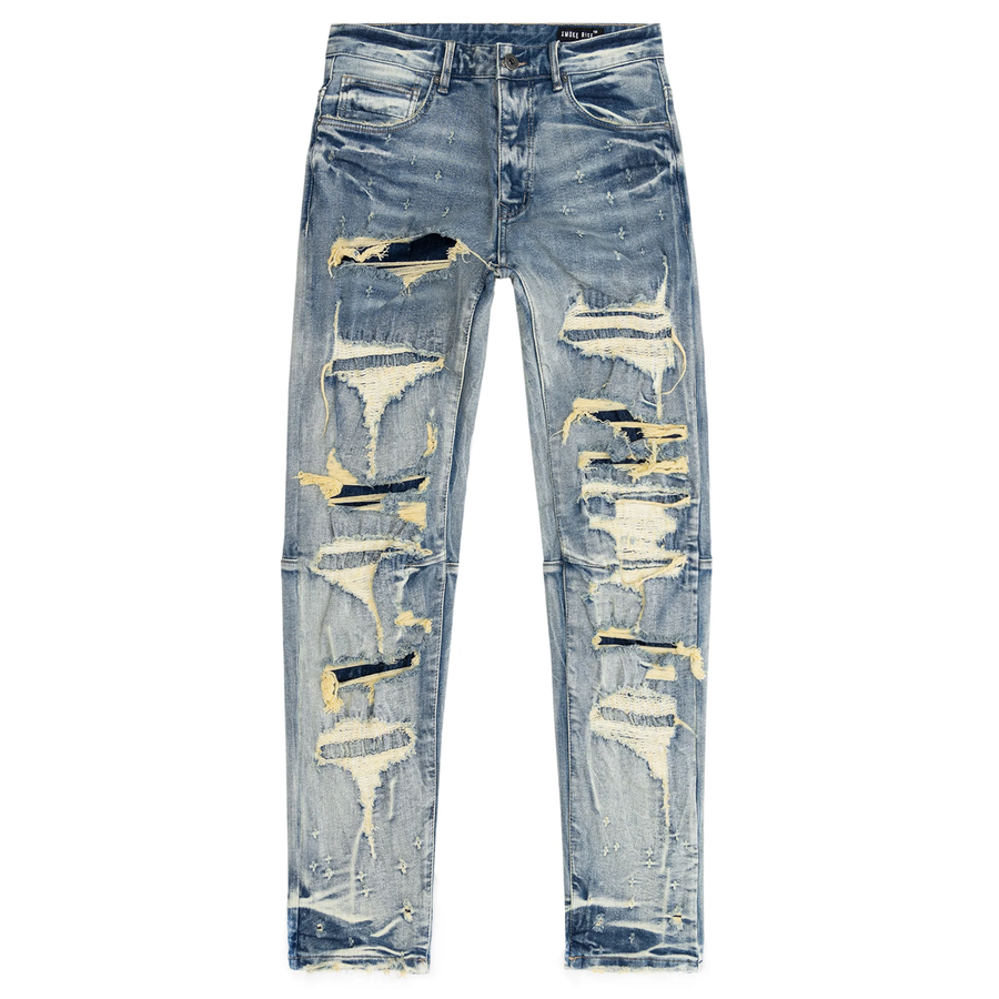 A pair of slim fit, distressed denim jeans with zigzag stitching details and a bleached wash.